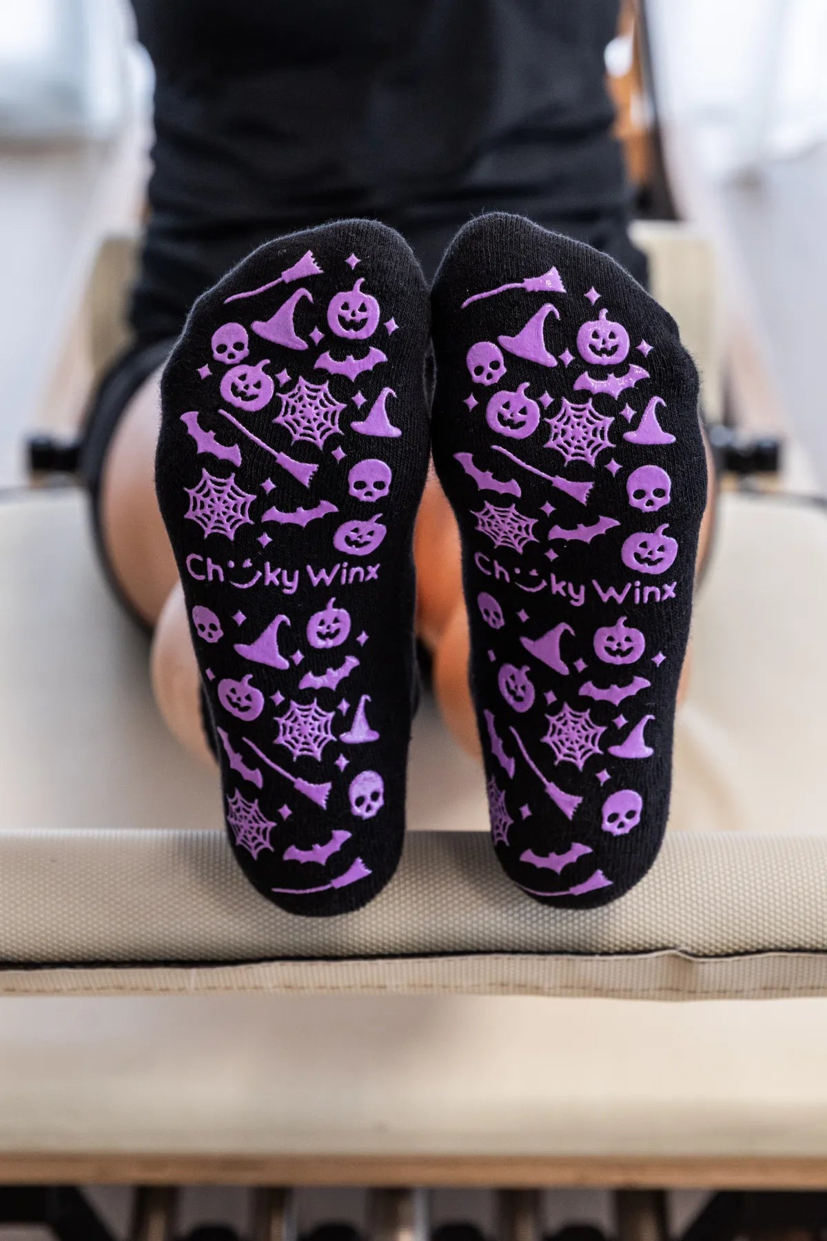 Black crew grip socks with spooky purple Halloween grip featuring webs, bats, and pumpkins by Cheeky Winx. Non-slip sole for reformer, Pilates, yoga, and barre. Australia's best grip socks.